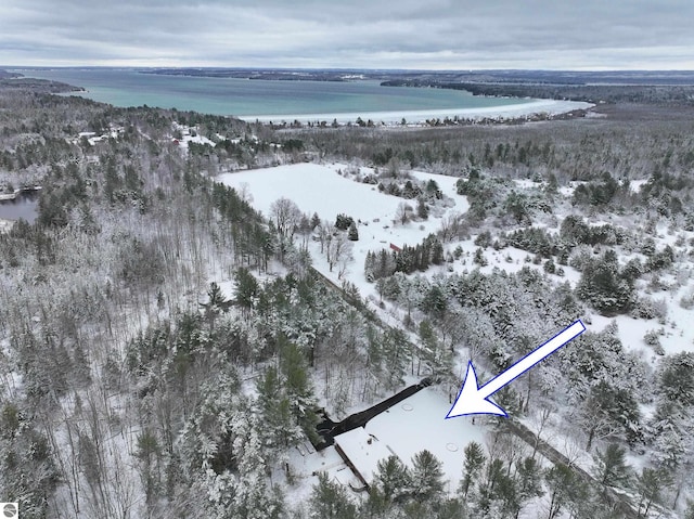 snowy aerial view featuring a water view