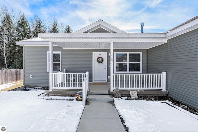 view of front facade with a porch and fence