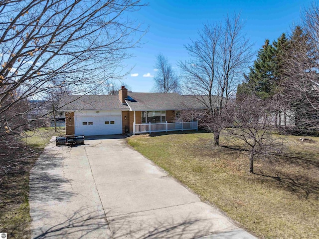 ranch-style home with a chimney, a front lawn, concrete driveway, covered porch, and a garage