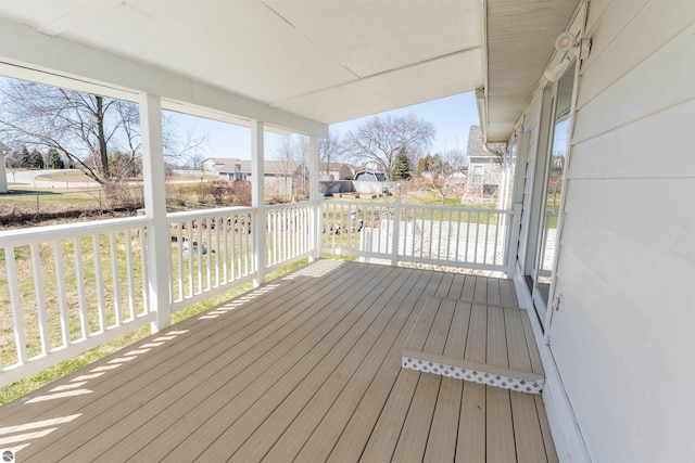 deck with covered porch and a residential view