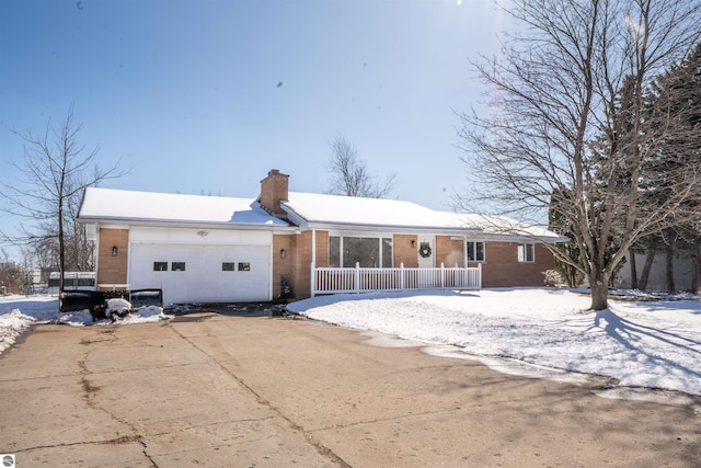 view of front of home with a chimney, driveway, fence, and a garage