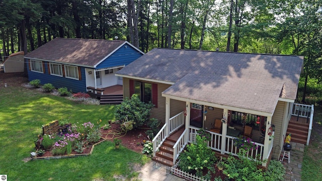 160 White Birch Ln, Cadillac, MI 49601 - view of front facade with covered porch, a front lawn, and roof with shingles
