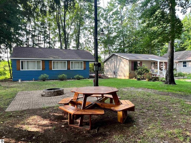 160 White Birch Ln, Cadillac, MI 49601 - exterior space with a lawn and a fire pit