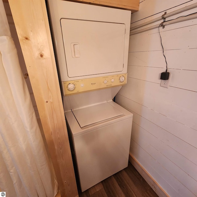 9701 S Lake Station Ave, Lake, MI 48632 - clothes washing area featuring stacked washer / dryer, dark wood-style floors, and wood walls