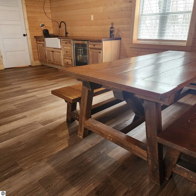 9701 S Lake Station Ave, Lake, MI 48632 - dining space featuring wood finished floors, wine cooler, and wooden walls