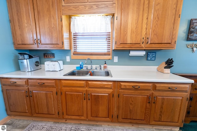 9701 S Lake Station Ave, Lake, MI 48632 - kitchen with light countertops, a sink, and brown cabinets