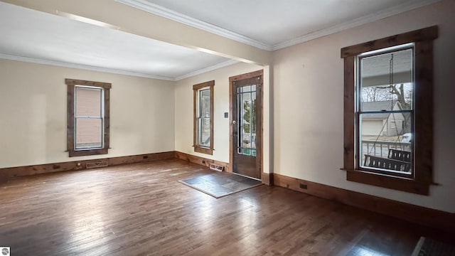 foyer entrance featuring baseboards, visible vents, ornamental molding, and wood finished floors