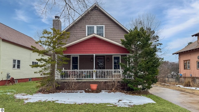 view of front of property featuring covered porch and a chimney