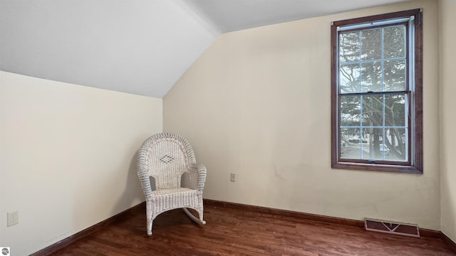 sitting room featuring plenty of natural light, visible vents, wood finished floors, and lofted ceiling