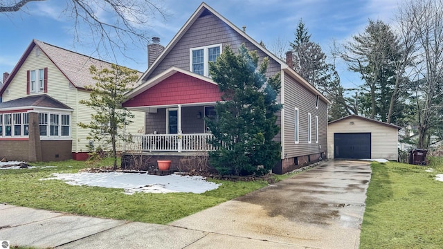 view of front of home featuring an outbuilding, driveway, a detached garage, covered porch, and a chimney