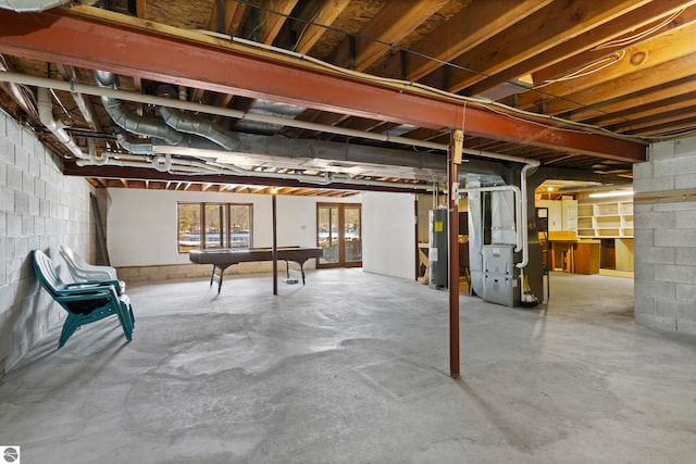 below grade area featuring water heater, heating unit, and pool table