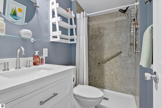 bathroom featuring a shower stall, toilet, and vanity