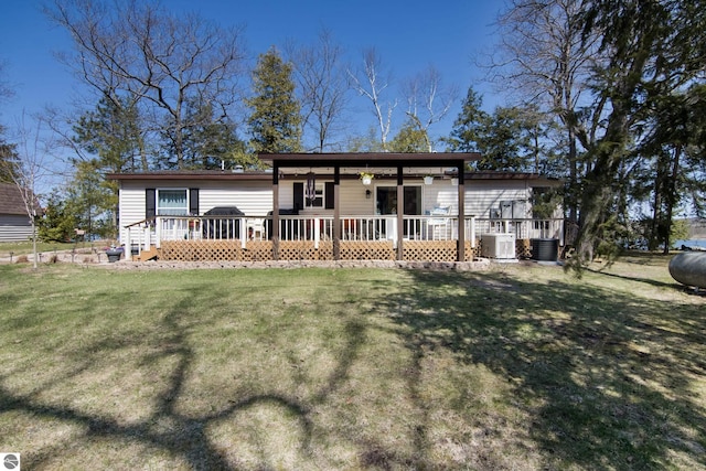 prairie-style house featuring central air condition unit, a front yard, and a wooden deck