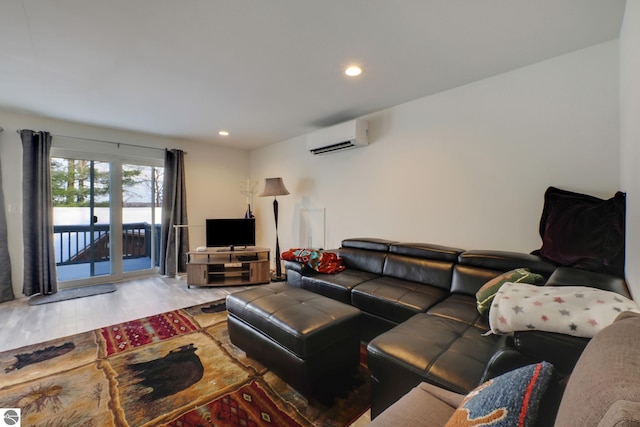 living area with recessed lighting, wood finished floors, and a wall mounted air conditioner