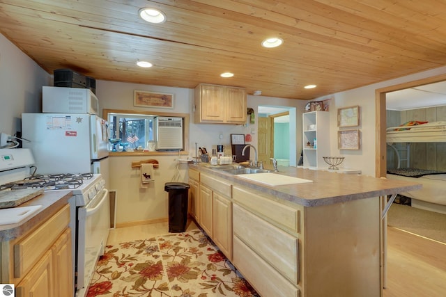 kitchen featuring a sink, light brown cabinets, white appliances, a peninsula, and wood ceiling