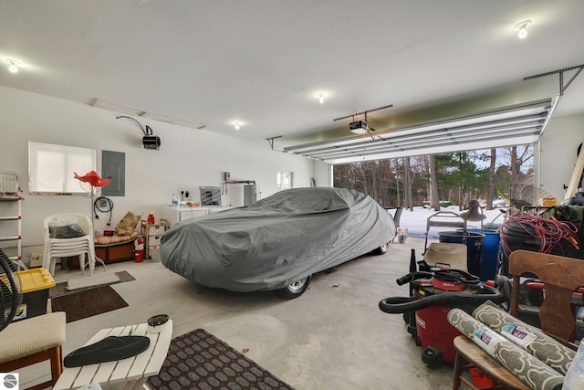 garage with a garage door opener and electric panel