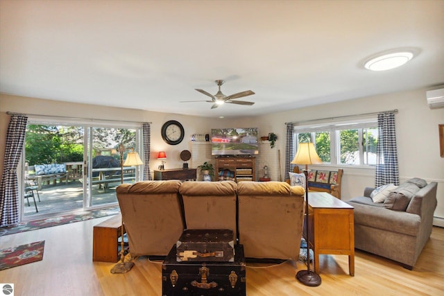 living area featuring light wood-type flooring and ceiling fan