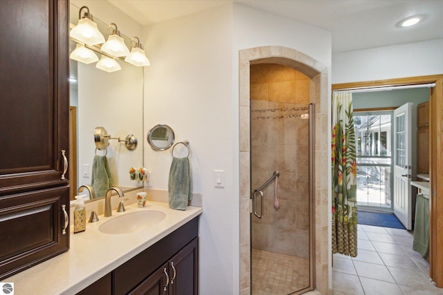 bathroom with tile patterned flooring, vanity, a stall shower, and recessed lighting