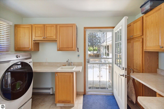 laundry room featuring a sink, a baseboard radiator, washer / dryer, light tile patterned floors, and cabinet space