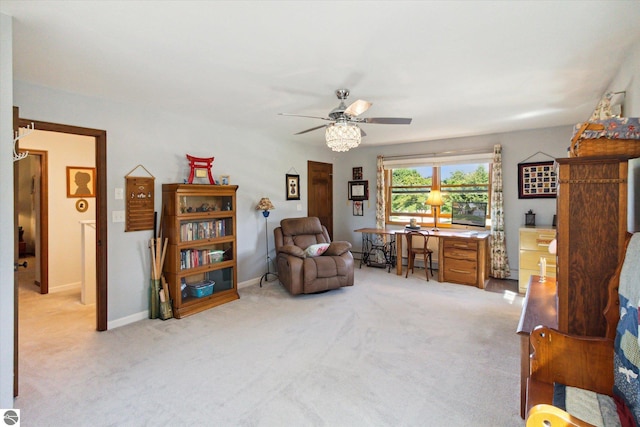 sitting room featuring baseboards, ceiling fan, and light colored carpet