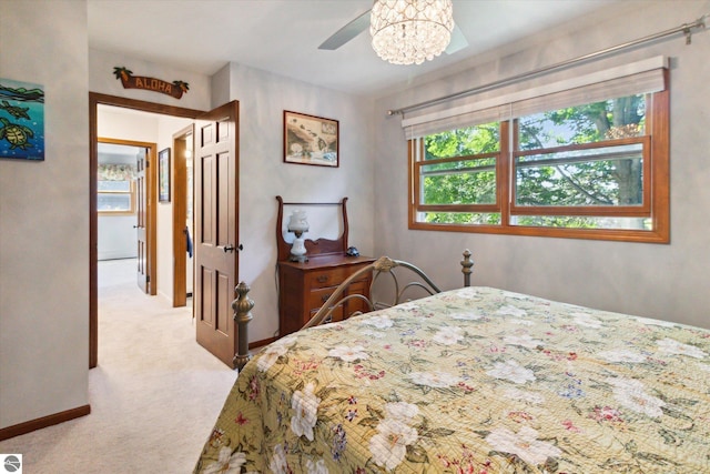bedroom with light carpet and baseboards