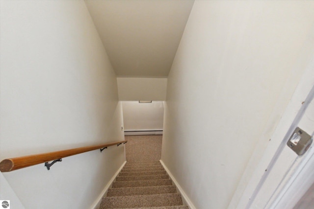 stairway with a baseboard radiator, baseboards, and carpet flooring