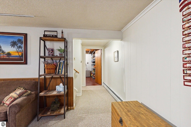 hall featuring a baseboard radiator, carpet, and a textured ceiling