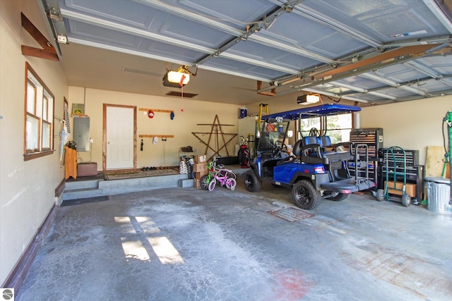 garage featuring electric panel and a garage door opener