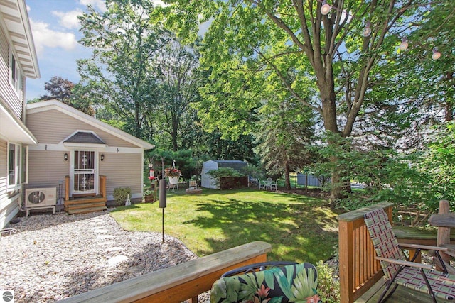 view of yard featuring an outbuilding and ac unit