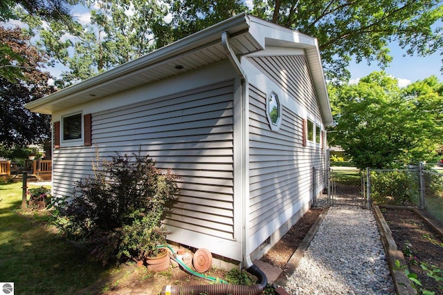 view of property exterior with a gate and fence