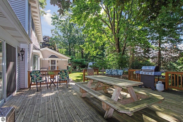 wooden terrace with outdoor dining space