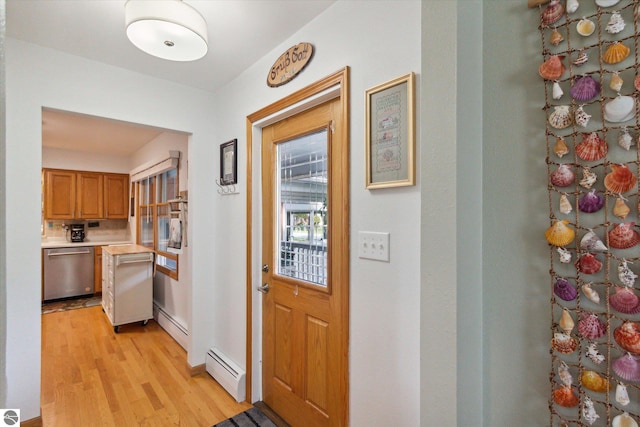 doorway with a baseboard radiator and light wood finished floors