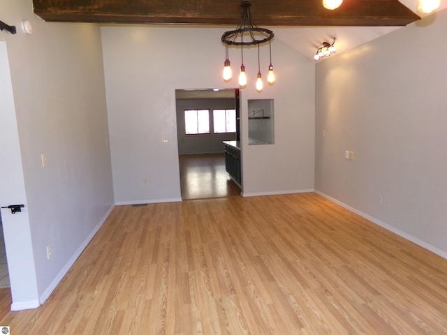 unfurnished room with light wood-type flooring and baseboards