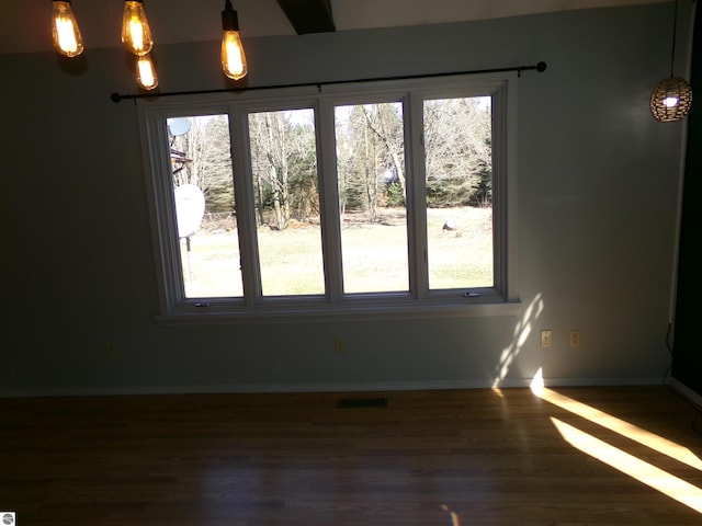 interior space with baseboards and dark wood-type flooring