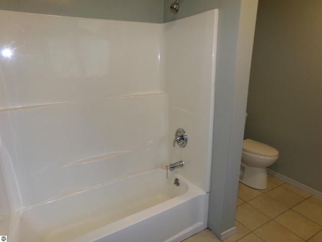 bathroom featuring tile patterned flooring, shower / bathing tub combination, toilet, and baseboards