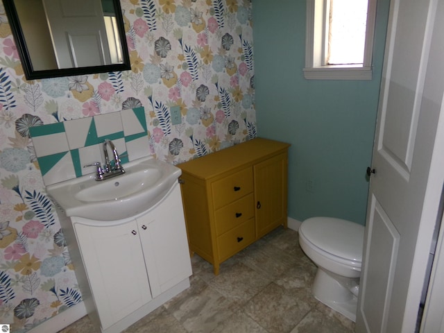 bathroom featuring toilet and vanity