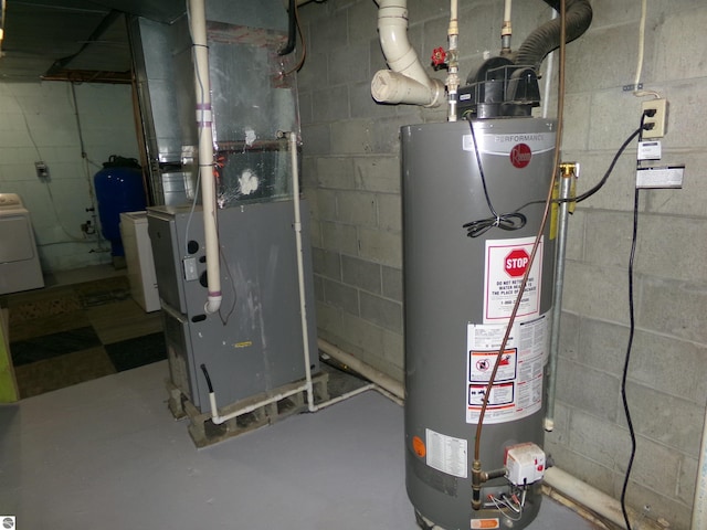 utility room featuring washer / dryer, gas water heater, and heating unit