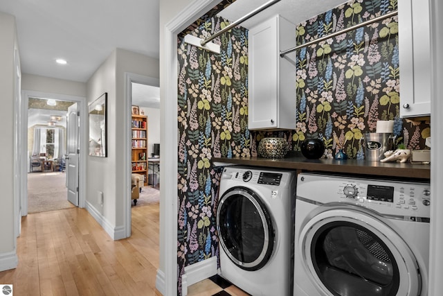 laundry room featuring washing machine and dryer, cabinet space, baseboards, light wood-style floors, and recessed lighting