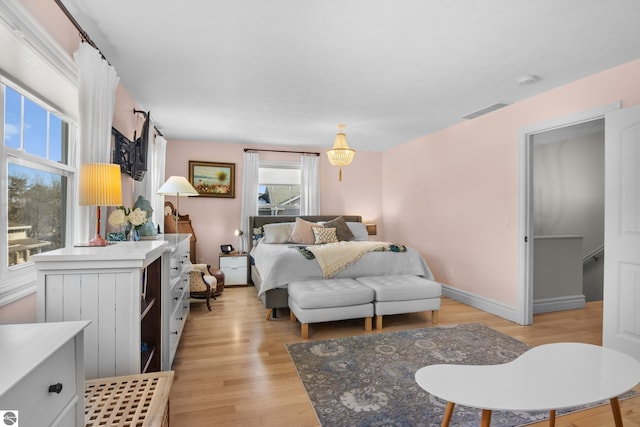 bedroom featuring light wood-style flooring and baseboards