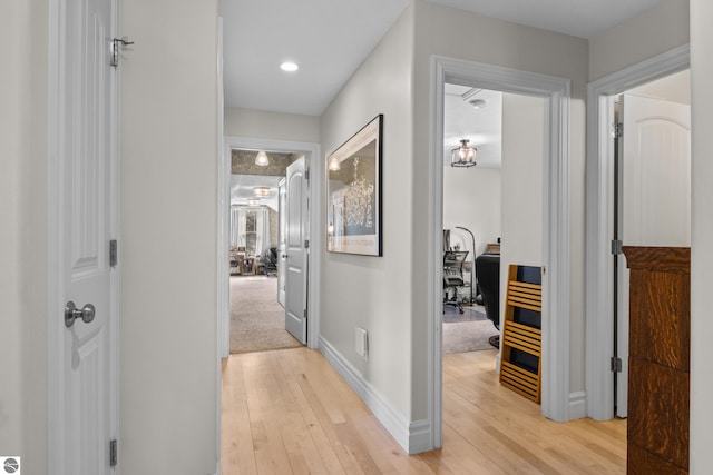 corridor with light wood-style floors, baseboards, an office area, and recessed lighting