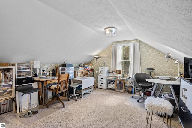 home office featuring carpet flooring, lofted ceiling, and a textured ceiling