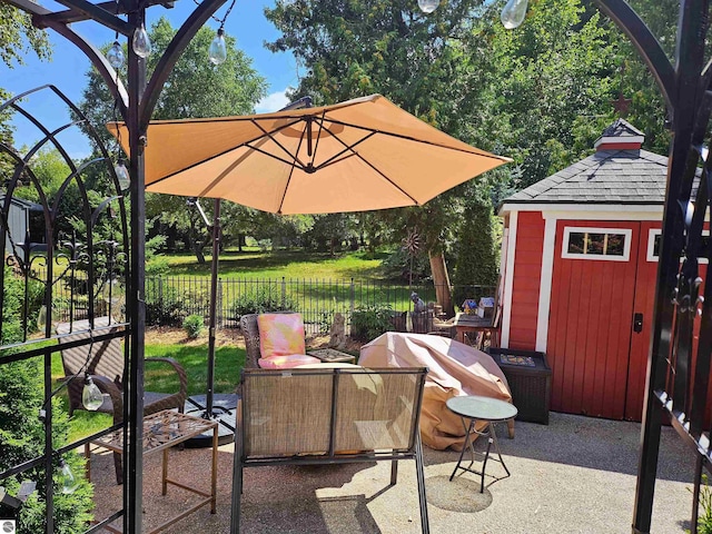 view of patio / terrace featuring fence, outdoor lounge area, and an outdoor structure
