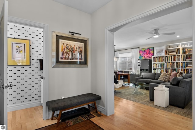 corridor featuring wood finished floors and baseboards
