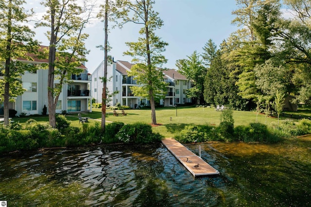 750 Centre Pl Unit 5, Traverse City, MI 49686 - dock featuring a water view and a lawn
