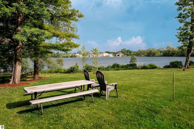 750 Centre Pl Unit 5, Traverse City, MI 49686 - view of property's community with a water view and a lawn