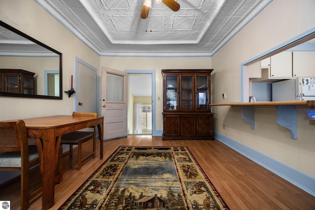 entryway with baseboards, ornamental molding, wood finished floors, and a ceiling fan