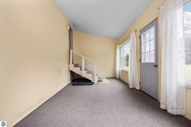 entryway featuring carpet floors and stairway