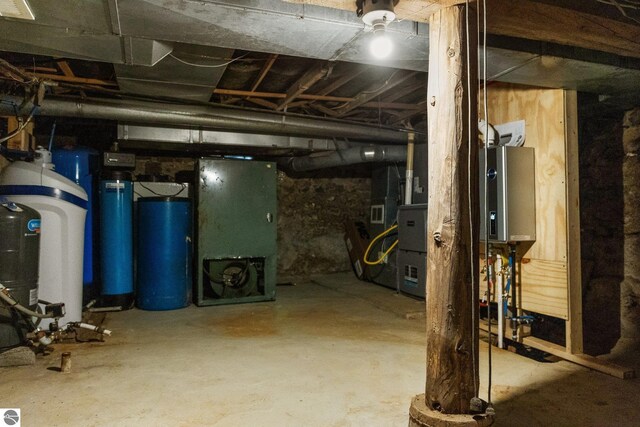 unfinished basement featuring water heater