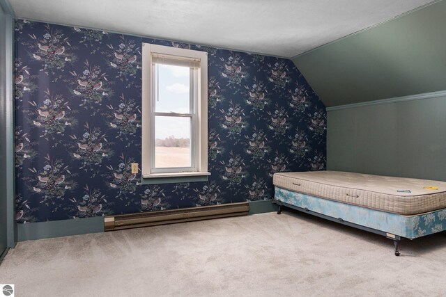 unfurnished bedroom featuring wallpapered walls, carpet, vaulted ceiling, and baseboard heating
