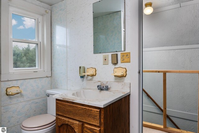 half bathroom featuring toilet and vanity